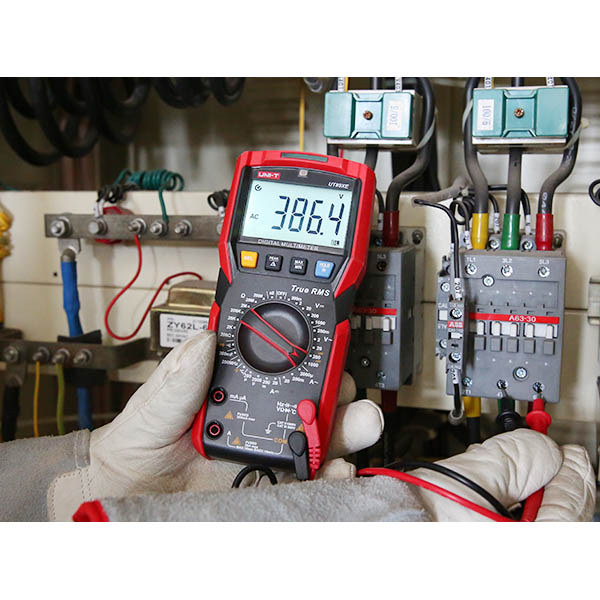 UT89X multimeter measuring AC voltage in an electrical panel